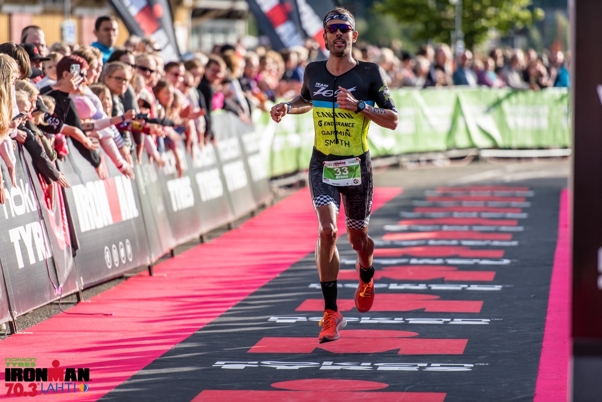 Breno Melo finishing the Ironman 70.3 in Lahti, Finland with a crowd cheering