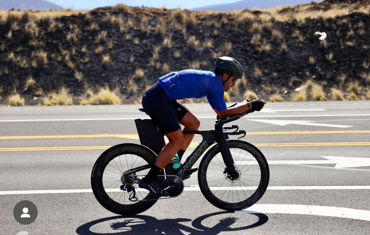 Cyclist in a time trial position during a triathlon race in Kona, Hawaii.