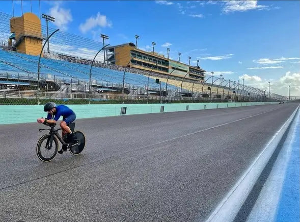 Cyclist in aero position racing at the Pro Race Challenge in Miami Homestead, FL, on a time trial bike