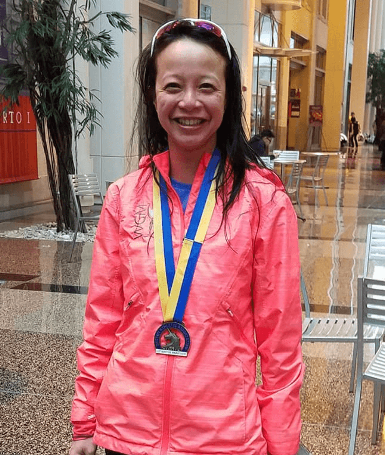 NYC Marathon qualifier with 1:48 half-marathon PB and 3:50 marathon PB, smiling and wearing medals.